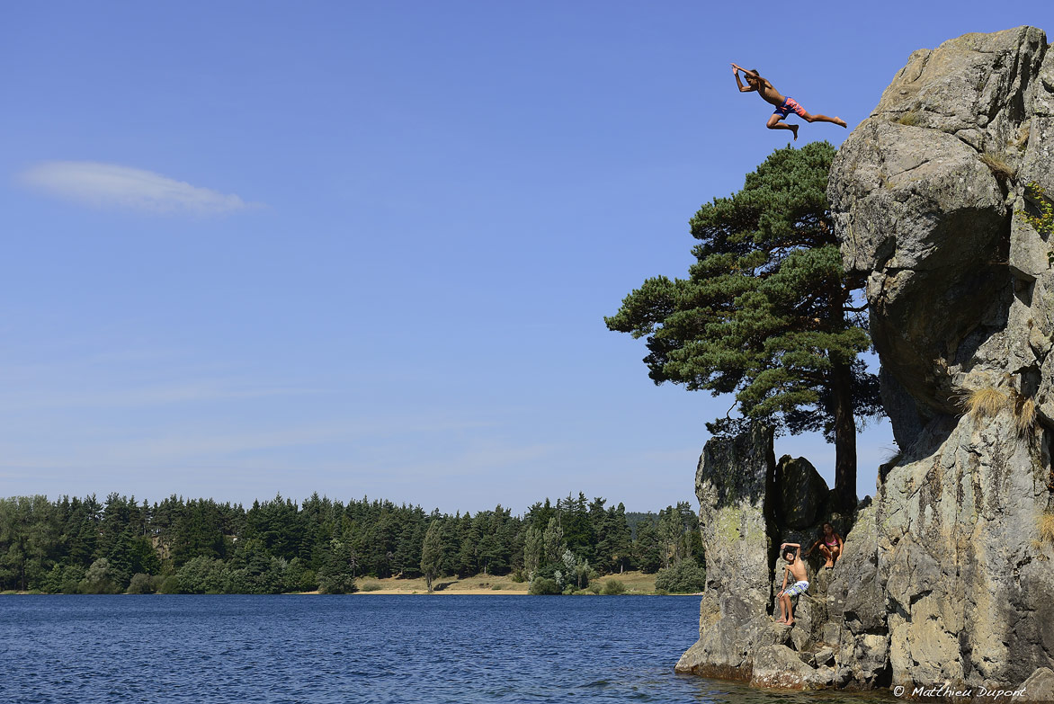 Un enfant saute depuis un rocher dans les eaux du Lac d'Issarlès en Ardèche. Photo Matthieu Dupont